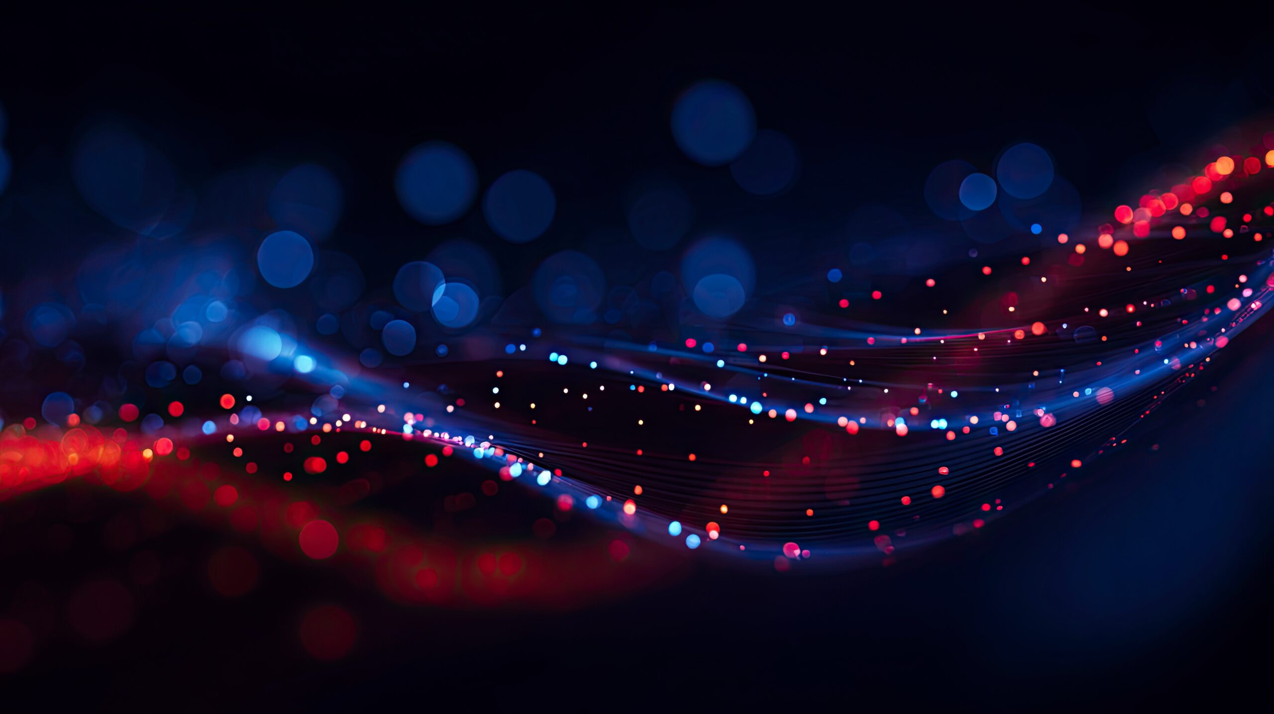 Abstract wave of particles and dots on a dark blue background, with a glowing effect and a red glow of light. A blue gradient background with bokeh lights, suitable for a banner design. An abstract digital technology wallpaper, suitable as a background for a presentation or website. Stock photo with 2/3 of the space available for text. --ar 16:9 --v 7 Job ID: d55277c5-cd2c-4237-8d88-efb52363857a